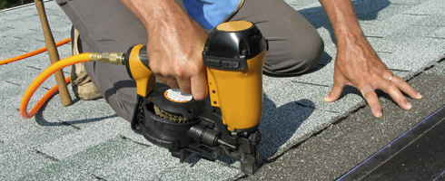 Roofer with nail gun